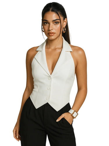 Woman wearing a white sleeveless vest over black pants on a white background